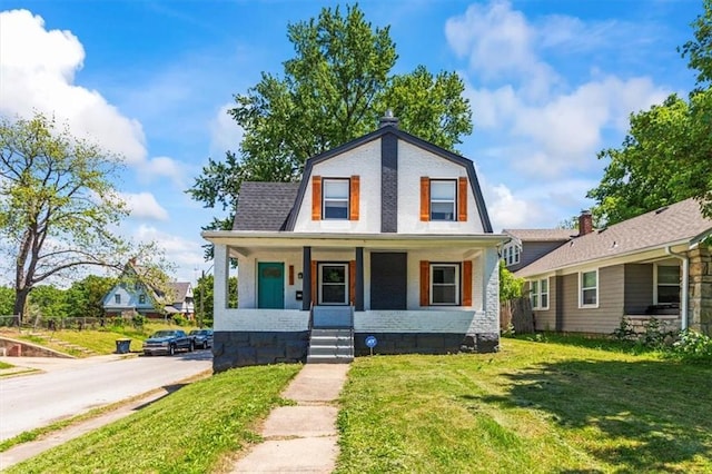 6101 Swope Pkwy, Kansas City, MO 64130 - colonial inspired home with covered porch, a front yard, and a gambrel roof