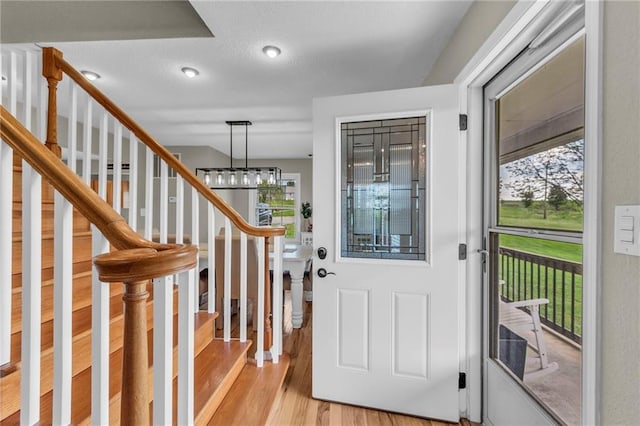 entrance foyer with stairs and light wood-style floors