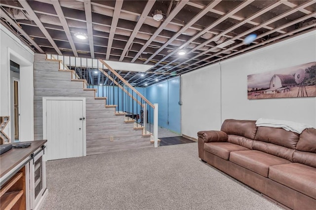 finished below grade area featuring stairs and carpet