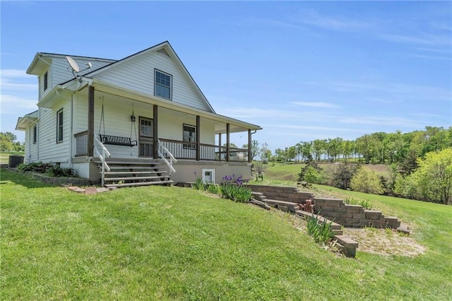 farmhouse-style home featuring a porch, a front lawn, and central AC unit