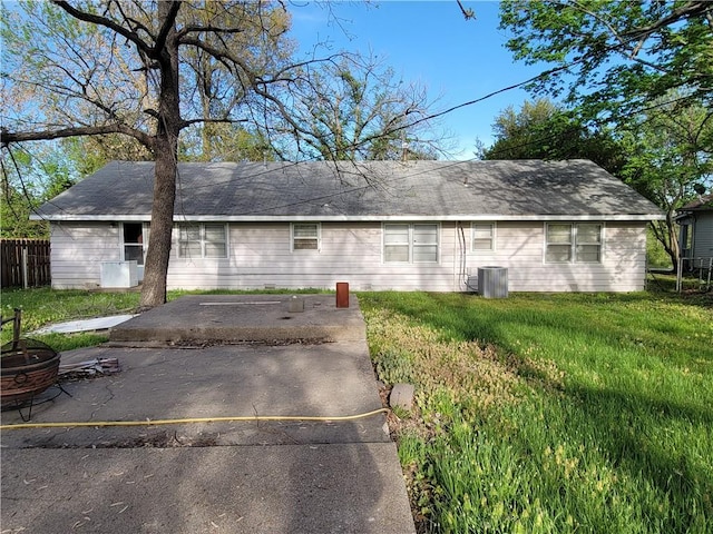 rear view of property with a lawn and fence