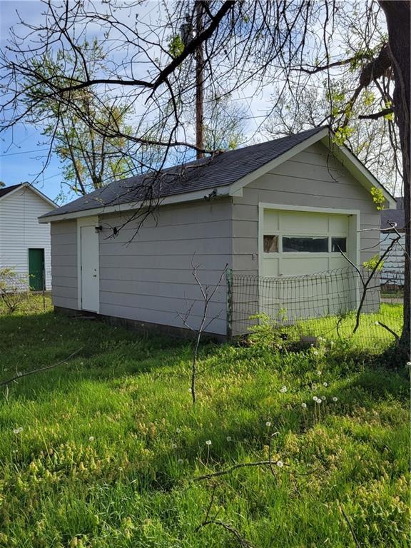 detached garage featuring fence