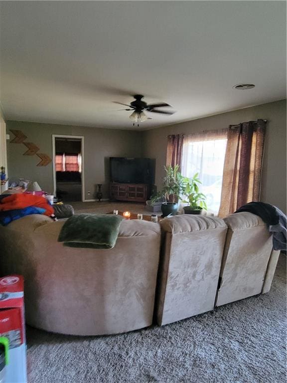 living room featuring ceiling fan and carpet