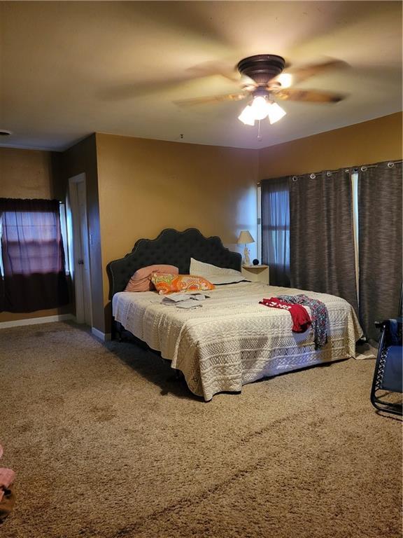 bedroom featuring a ceiling fan and carpet