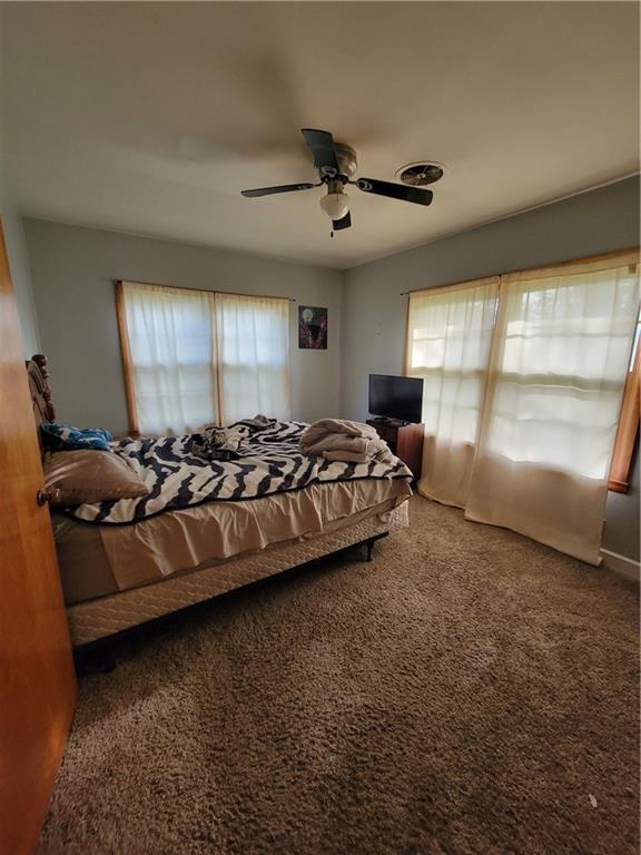 carpeted bedroom with a ceiling fan