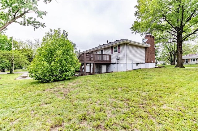 back of property featuring a lawn, stairway, a wooden deck, and a chimney