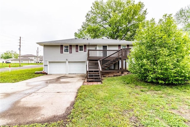 view of front of house with a garage, a front yard, a deck, concrete driveway, and stairway