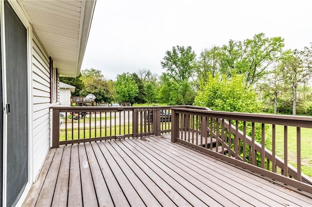wooden terrace featuring a lawn