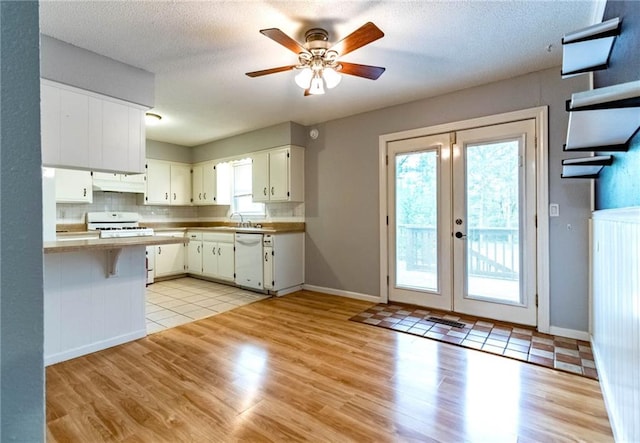 kitchen featuring visible vents, a ceiling fan, light wood-style flooring, and dishwasher