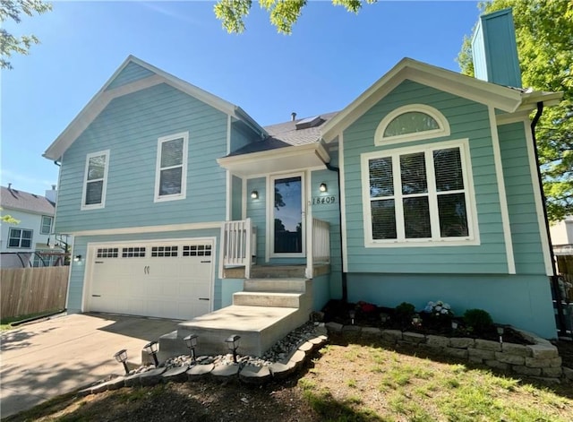 view of front of property with a garage, fence, and driveway