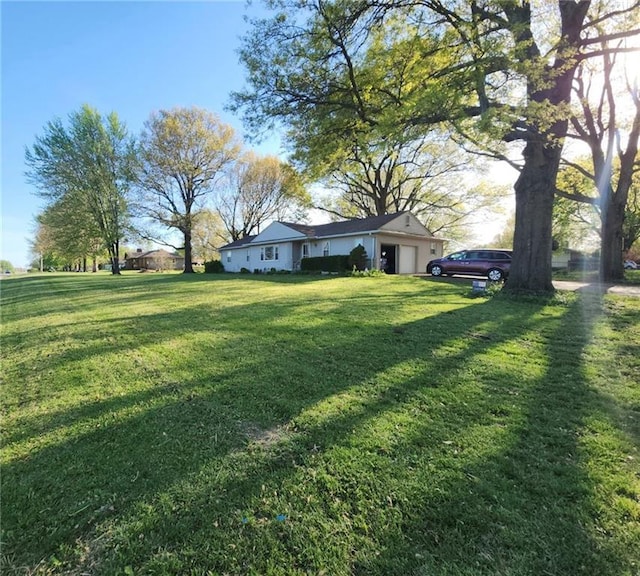 26335 W 321st Ter, Paola, KS 66071 - view of green lawn with a garage