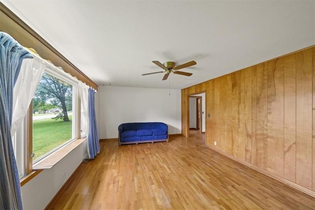 26335 W 321st Ter, Paola, KS 66071 - unfurnished room with light wood finished floors, a ceiling fan, and wooden walls