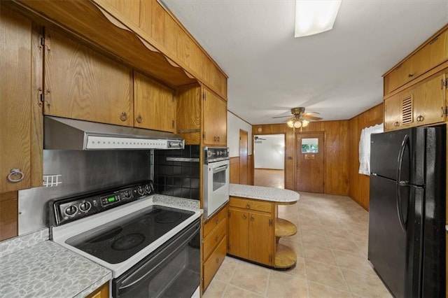 26335 W 321st Ter, Paola, KS 66071 - kitchen featuring freestanding refrigerator, range with electric stovetop, white oven, under cabinet range hood, and light countertops