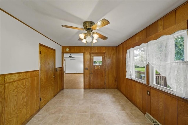 26335 W 321st Ter, Paola, KS 66071 - unfurnished room with wooden walls, healthy amount of natural light, and ceiling fan