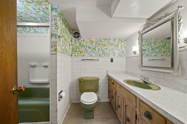 26335 W 321st Ter, Paola, KS 66071 - full bathroom featuring wallpapered walls, vanity, tile walls, a wainscoted wall, and a shower