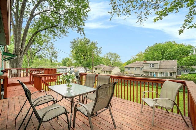 deck featuring a residential view and outdoor dining space