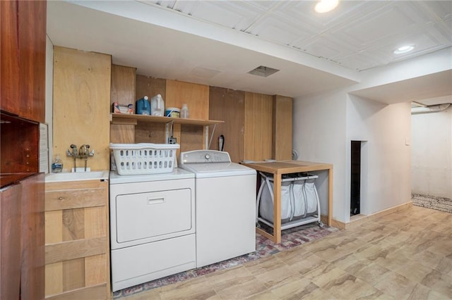 laundry area featuring washer and dryer, recessed lighting, and light floors