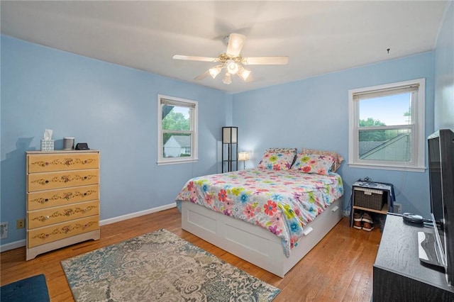 bedroom featuring baseboards, a ceiling fan, and wood finished floors