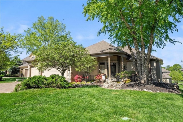 10522 N Garfield Ave, Kansas City, MO 64155 - view of property hidden behind natural elements featuring a front lawn, an attached garage, and stucco siding