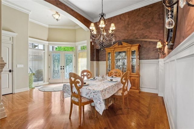 10522 N Garfield Ave, Kansas City, MO 64155 - dining space with a chandelier, french doors, a decorative wall, wainscoting, and wood finished floors