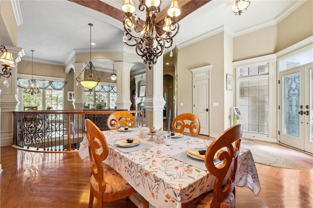 10522 N Garfield Ave, Kansas City, MO 64155 - dining room featuring a chandelier, wood finished floors, decorative columns, and crown molding