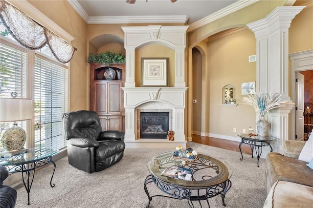 10522 N Garfield Ave, Kansas City, MO 64155 - living area with decorative columns, plenty of natural light, a large fireplace, and ornamental molding