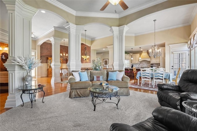 10522 N Garfield Ave, Kansas City, MO 64155 - living room with light wood-type flooring, ornate columns, ceiling fan, ornamental molding, and a chandelier