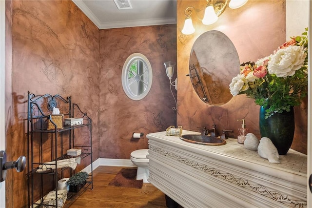 10522 N Garfield Ave, Kansas City, MO 64155 - half bath with wood finished floors, baseboards, ornamental molding, toilet, and vanity