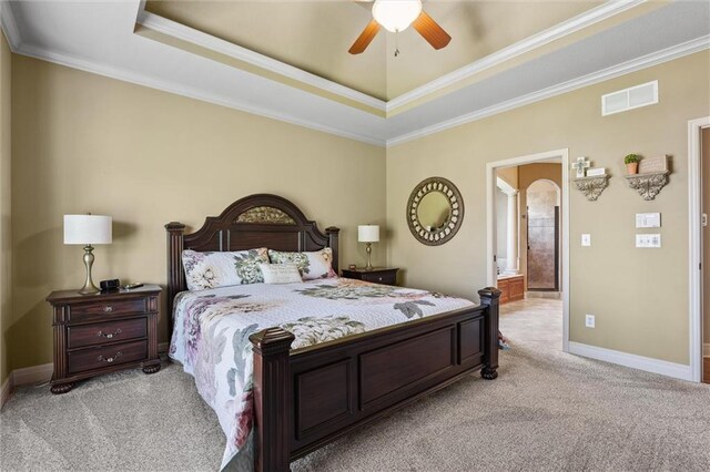 10522 N Garfield Ave, Kansas City, MO 64155 - bedroom with light carpet, a tray ceiling, crown molding, baseboards, and arched walkways