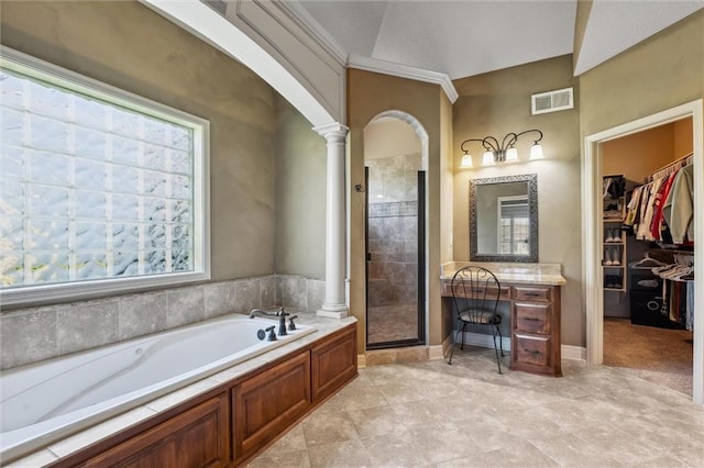 10522 N Garfield Ave, Kansas City, MO 64155 - bathroom featuring decorative columns, a shower stall, a garden tub, a walk in closet, and vanity