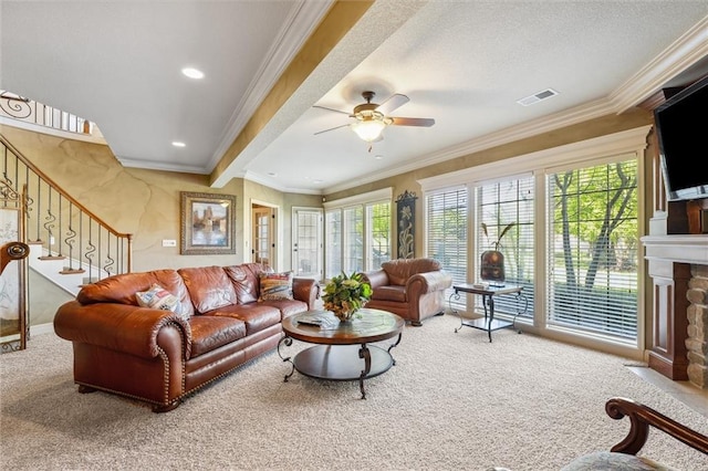 10522 N Garfield Ave, Kansas City, MO 64155 - carpeted living area with stairway, a ceiling fan, a stone fireplace, ornamental molding, and recessed lighting