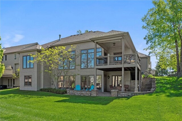 10522 N Garfield Ave, Kansas City, MO 64155 - back of property with a balcony, stucco siding, a patio, and a yard