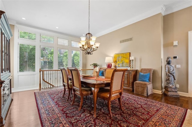 dining space with ornamental molding, a chandelier, wood finished floors, baseboards, and recessed lighting