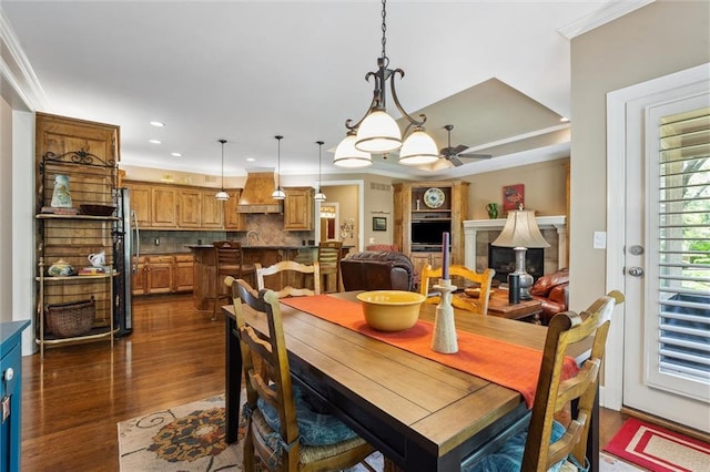 dining room with crown molding, dark wood-style flooring, a ceiling fan, and recessed lighting