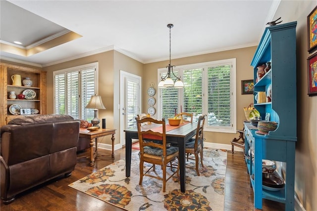 dining room with ornamental molding, dark wood-style flooring, and baseboards