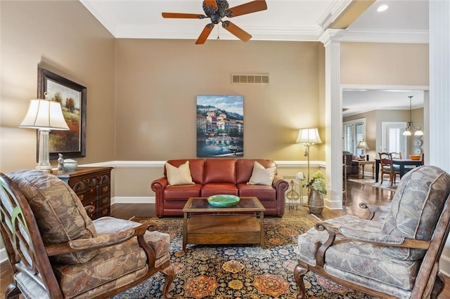 living area with wood finished floors, crown molding, a ceiling fan, baseboards, and recessed lighting