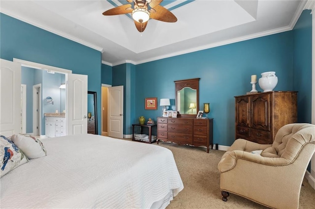 bedroom featuring a raised ceiling, carpet, crown molding, ceiling fan, and ensuite bathroom