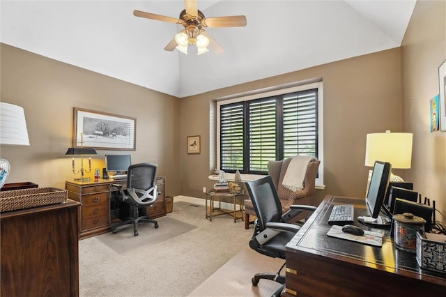 office area with carpet flooring, vaulted ceiling, ceiling fan, and baseboards