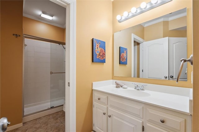 full bath featuring ornamental molding, tile patterned floors, vanity, tiled shower, and baseboards