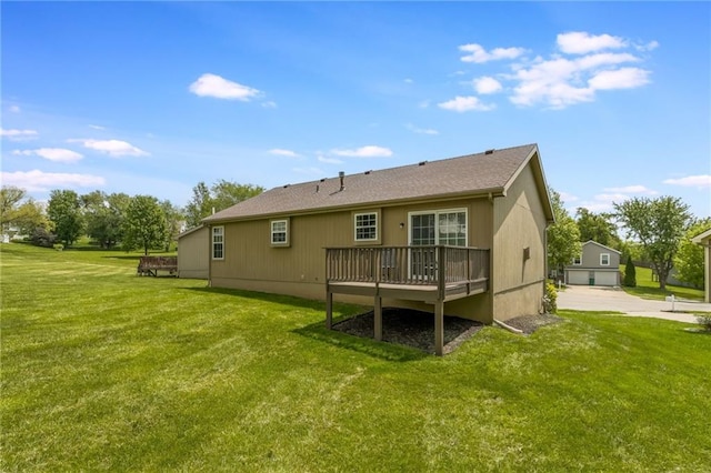 rear view of house with a wooden deck and a yard