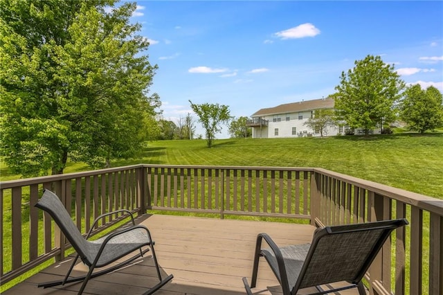 wooden terrace featuring a lawn