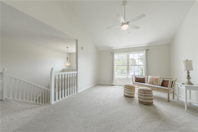 sitting room featuring an upstairs landing, carpet floors, ceiling fan, vaulted ceiling, and baseboards