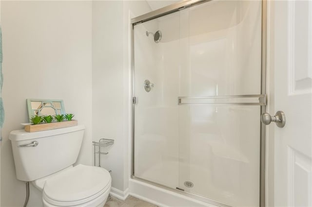full bath with a stall shower and toilet