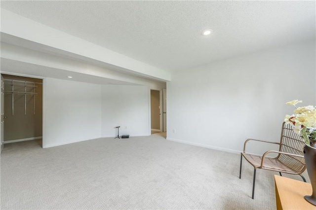unfurnished room featuring light colored carpet, baseboards, recessed lighting, and a textured ceiling