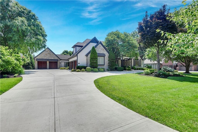 14575 Granada Cir, Leawood, KS 66224 - view of front of home with stone siding, a front lawn, and concrete driveway