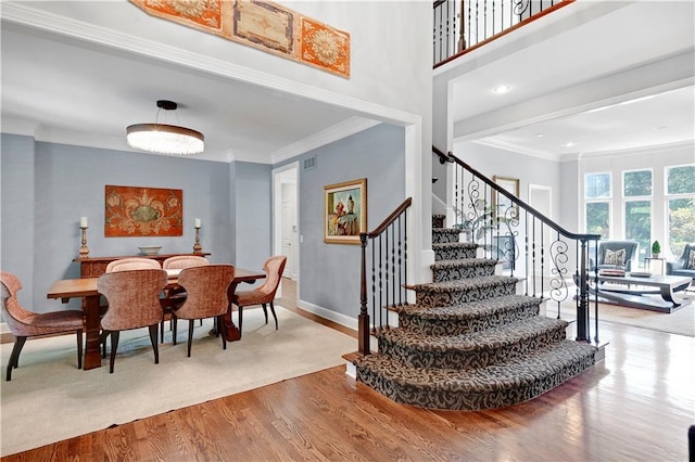 14575 Granada Cir, Leawood, KS 66224 - dining room with stairs, wood finished floors, and ornamental molding