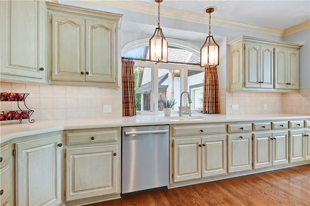 14575 Granada Cir, Leawood, KS 66224 - kitchen featuring stainless steel dishwasher, crown molding, cream cabinetry, hanging light fixtures, and light countertops