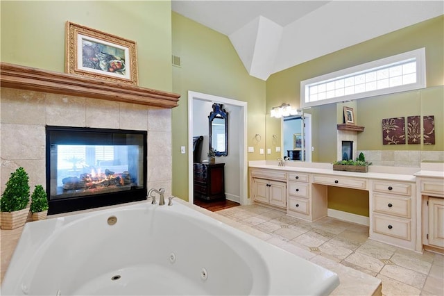 14575 Granada Cir, Leawood, KS 66224 - full bathroom featuring vanity, a jetted tub, a multi sided fireplace, and high vaulted ceiling
