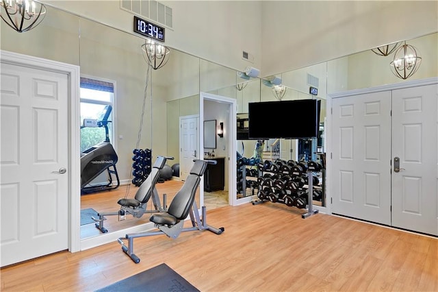 14575 Granada Cir, Leawood, KS 66224 - workout area with a chandelier and wood finished floors
