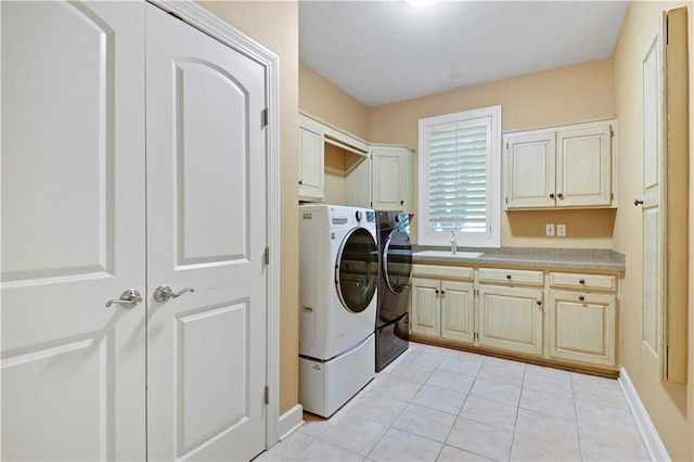 14575 Granada Cir, Leawood, KS 66224 - washroom with cabinet space, washing machine and dryer, and light tile patterned flooring